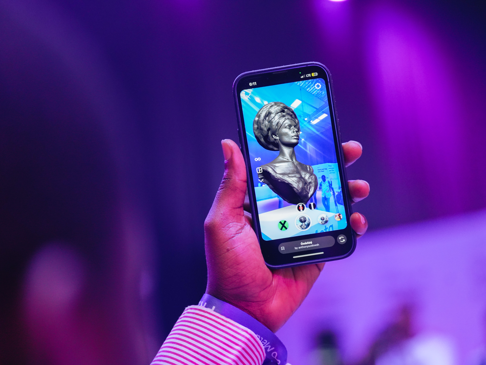 Person holding a phone with NFT on screen